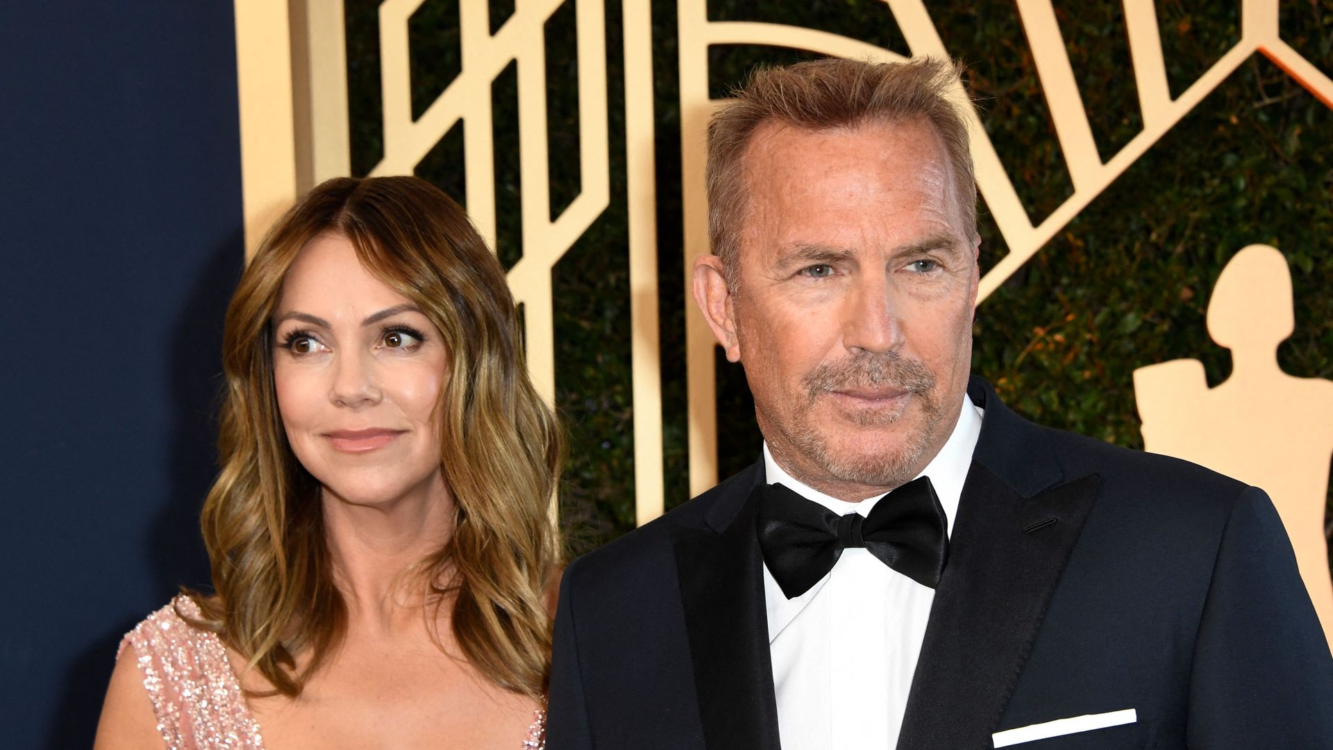 Kevin Costner and Christine Baumgartner arrive for the 28th Annual Screen Actors Guild (SAG) Awards in California on February 27, 2022