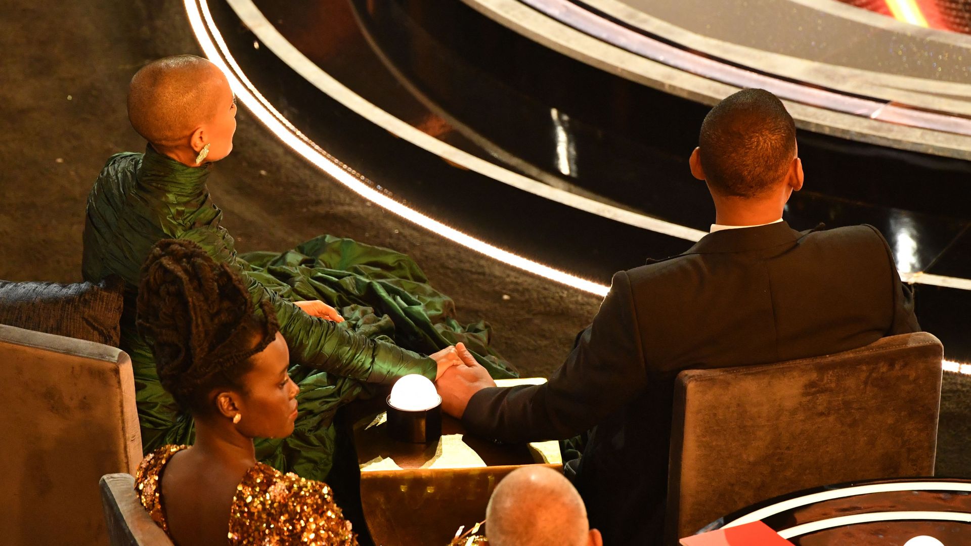 Will Smith sat holding Jada Pinkett Smith's hands at the Oscars in 2022