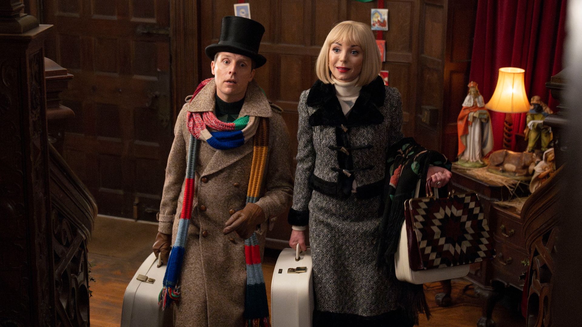 A man and woman walking up stairs with luggage