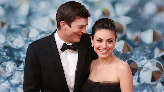 Mila Kunis and Ashton Kutcher with diamond backdrop