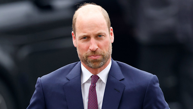 Prince William wearing navy suit and red tie