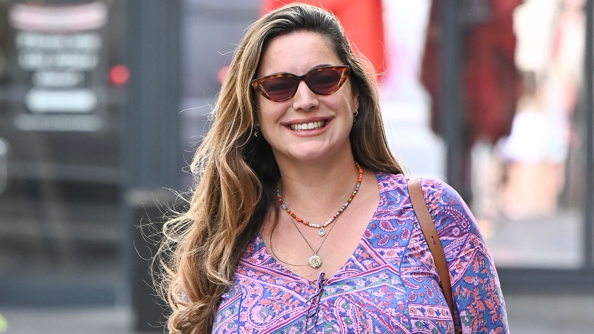 Kelly Brook turns heads in psychedelic mini dress and heels