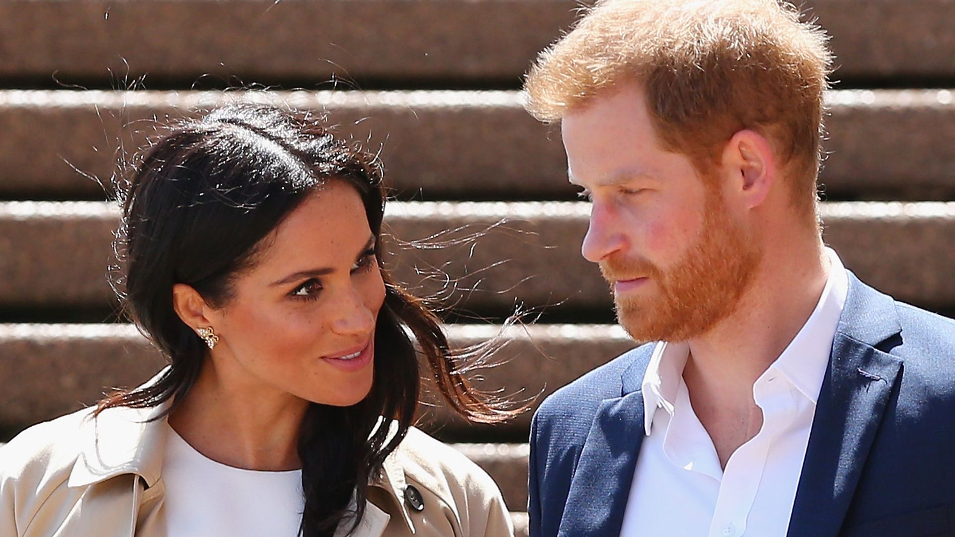 Prince Harry talking to Meghan Markle at the Sydney Opera House