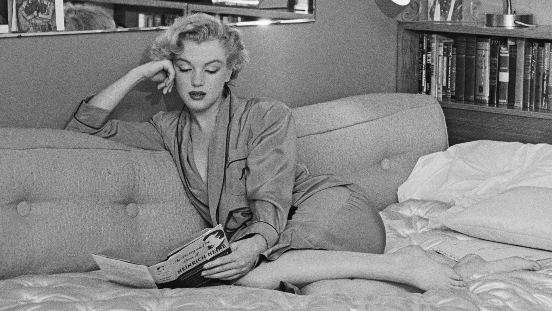 American actress Marilyn Monroe (1926 - 1962) relaxes on a sofa bed, circa 1951. The book she is reading is 'The Poetry and Prose of Heinrich Heine'. 