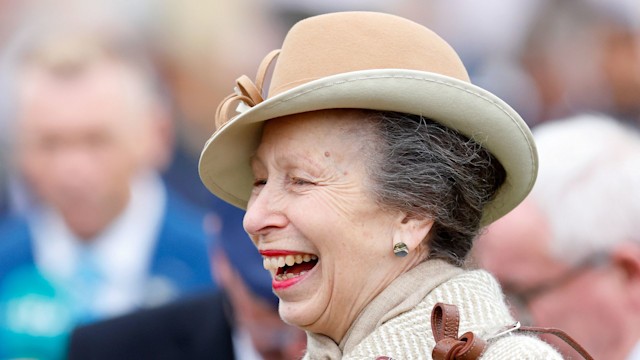 Princess Anne laughing in a smart hat