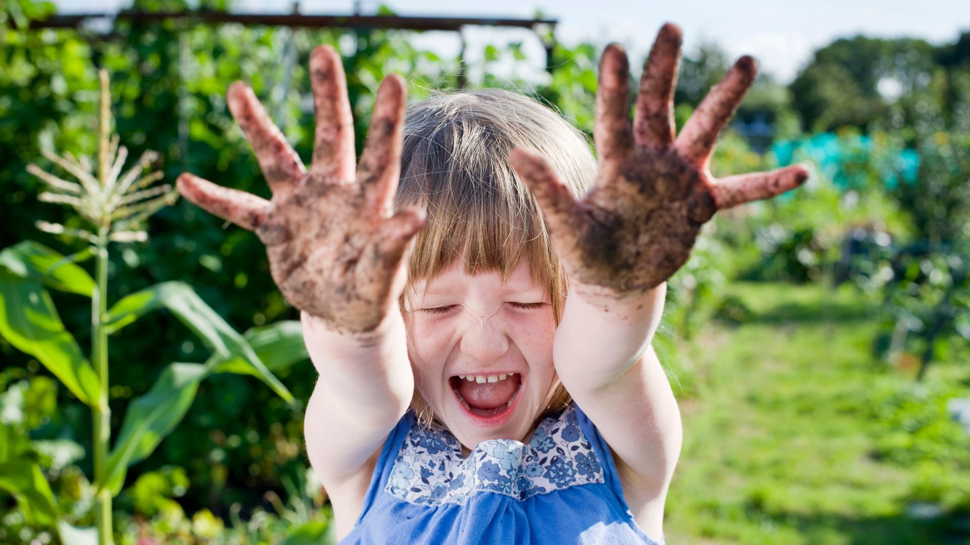 Girl with muddy hands