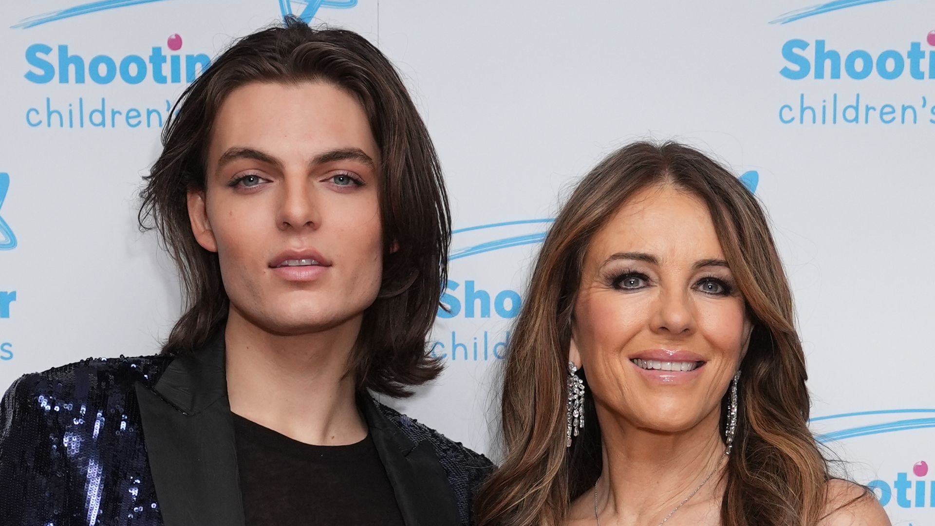 Elizabeth Hurley looks sensational in glittering split-leg dress as she joins son Damian at charity ball