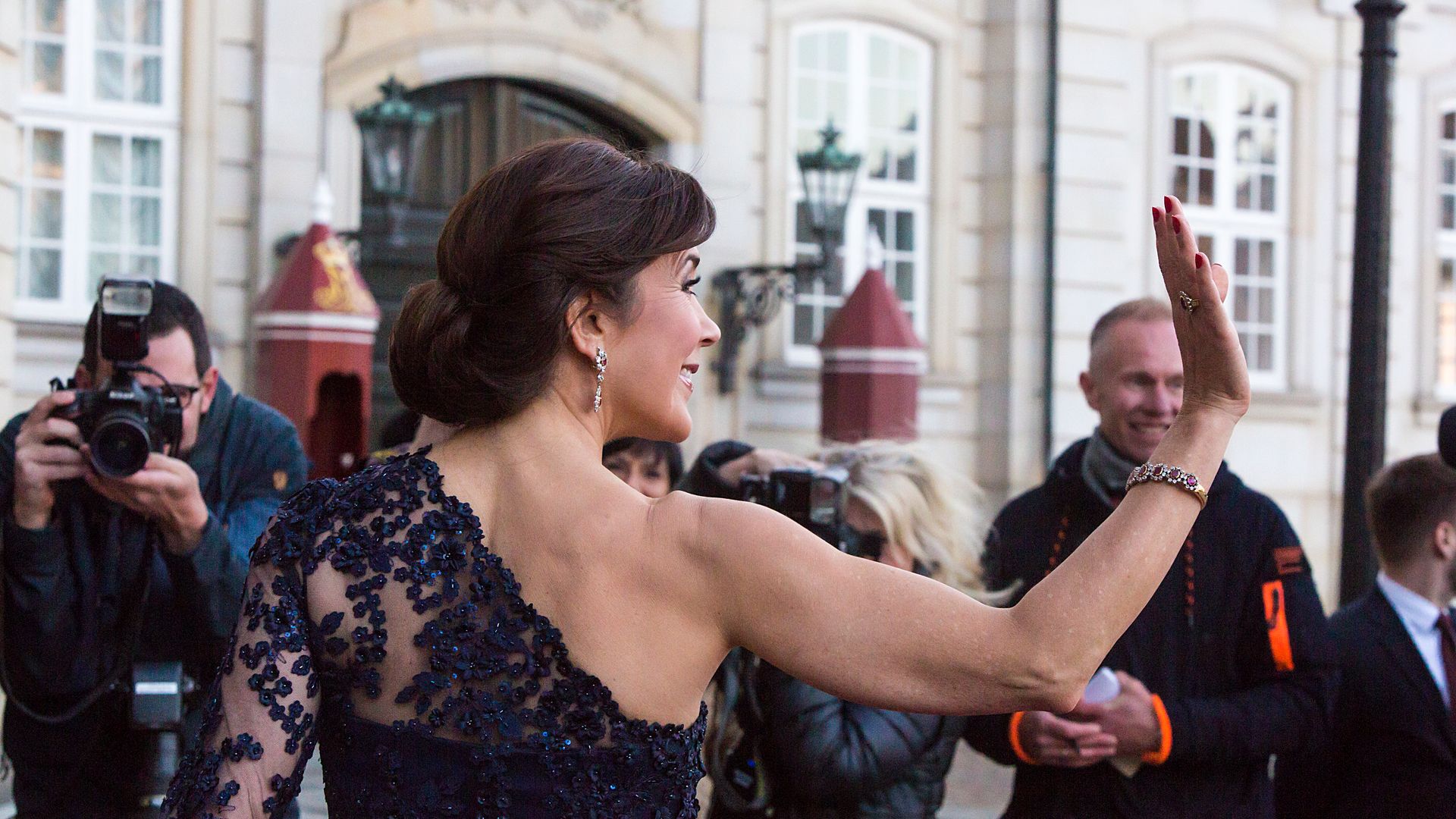 crown princess mary of denmark waving in navy dress