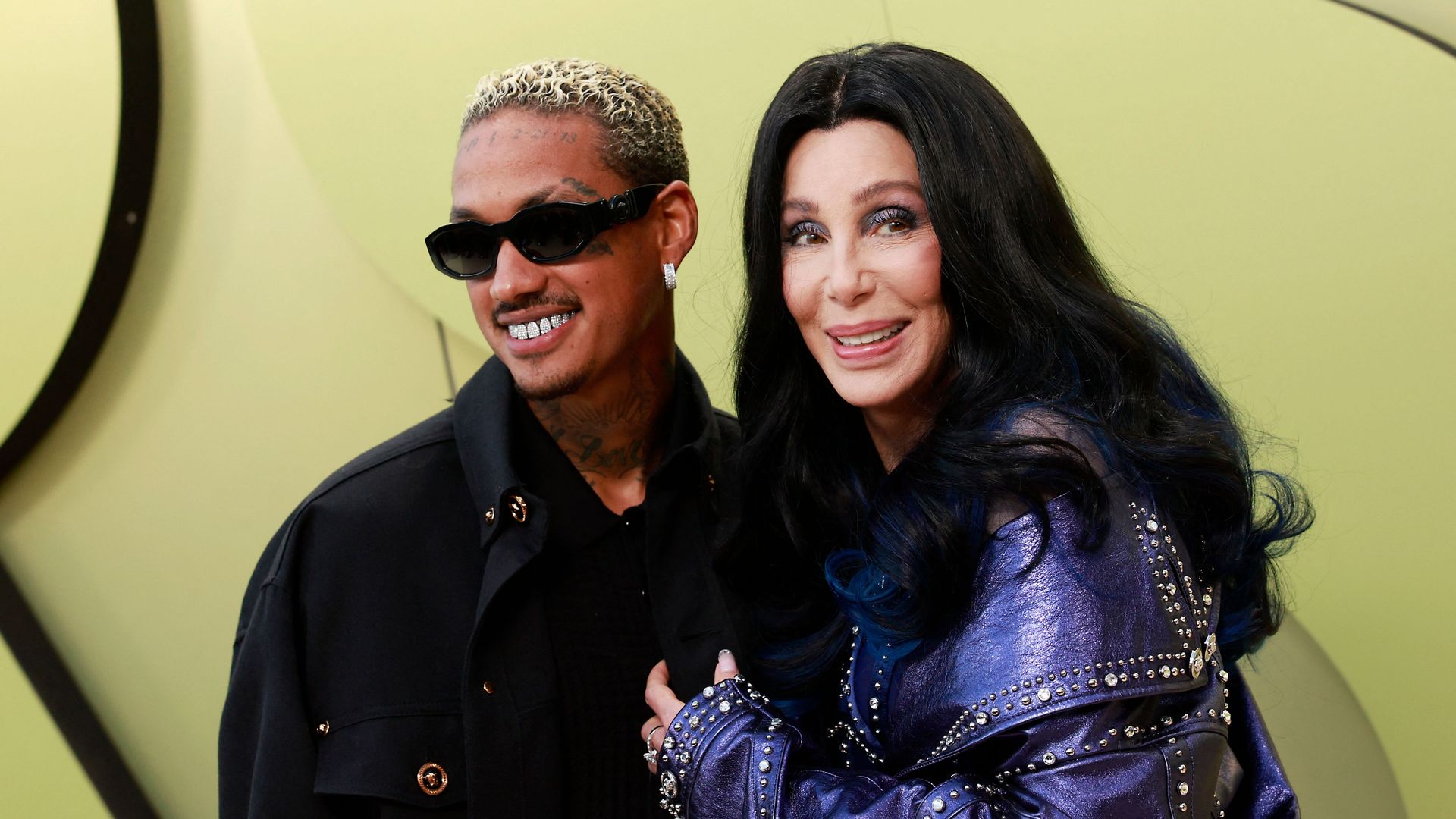 Cher and rapper Alexander Edwards arrive for the Versace Fall/Winter 2023 fashion show on March 9, 2023, at the Pacific Design Center in West Hollywood, California