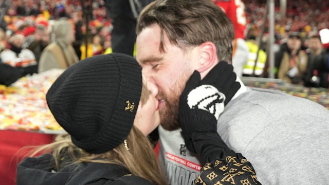 The couple shared a passionate kiss in front of hundreds of cameras before linking arms and walking back to the locker room together