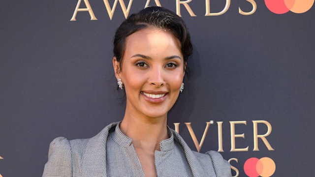 Maya Jama attends The Olivier Awards 2025 at The Royal Albert Hall on April 06, 2025 in London, England wearing a grey suit and updo hairstyle