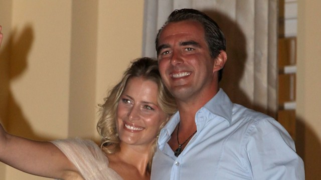 Prince Nikolaos and his fiance Tatiana Blatnik wave from the steps of the Poseidon Hotel as they attend their pre-wedding reception on August 24, 2010 in Spetses, Greece.