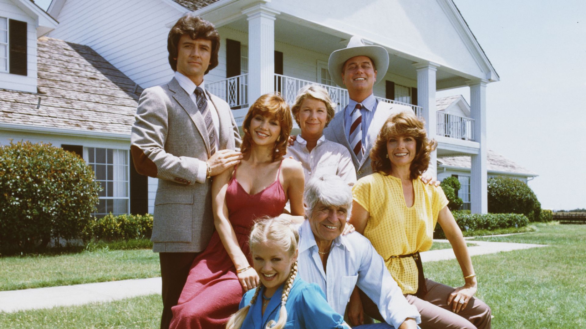 A promotional still from the American television series 'Dallas' shows members of the Ewing family as they pose in front of their television home, the Southfork Ranch, Dallas, Texas, 1979