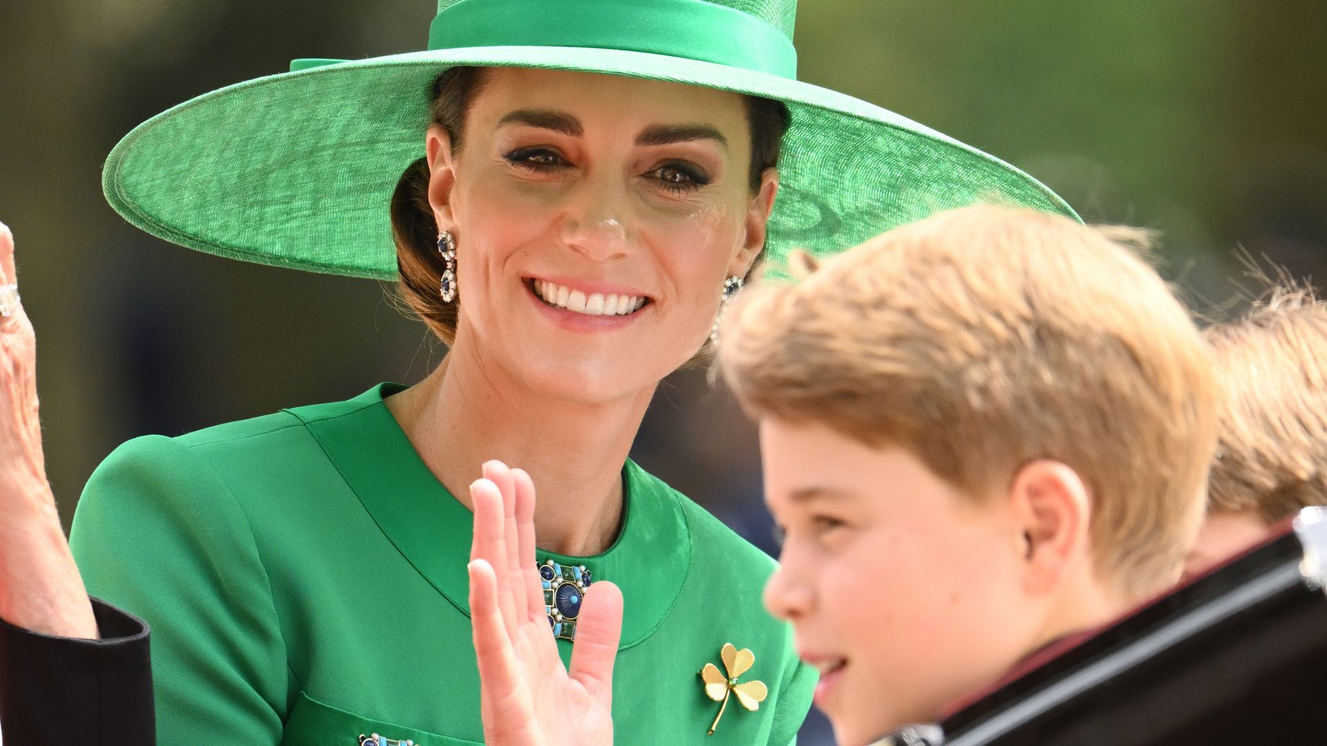 Catherine, Princess of Wales in green hat and Prince George in carriage