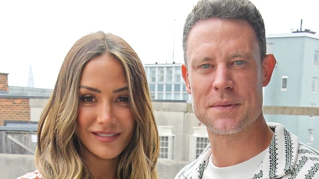 Frankie Bridge in a patterned jumpsuit with her husband Wayne Bridge in a stiped shirt
