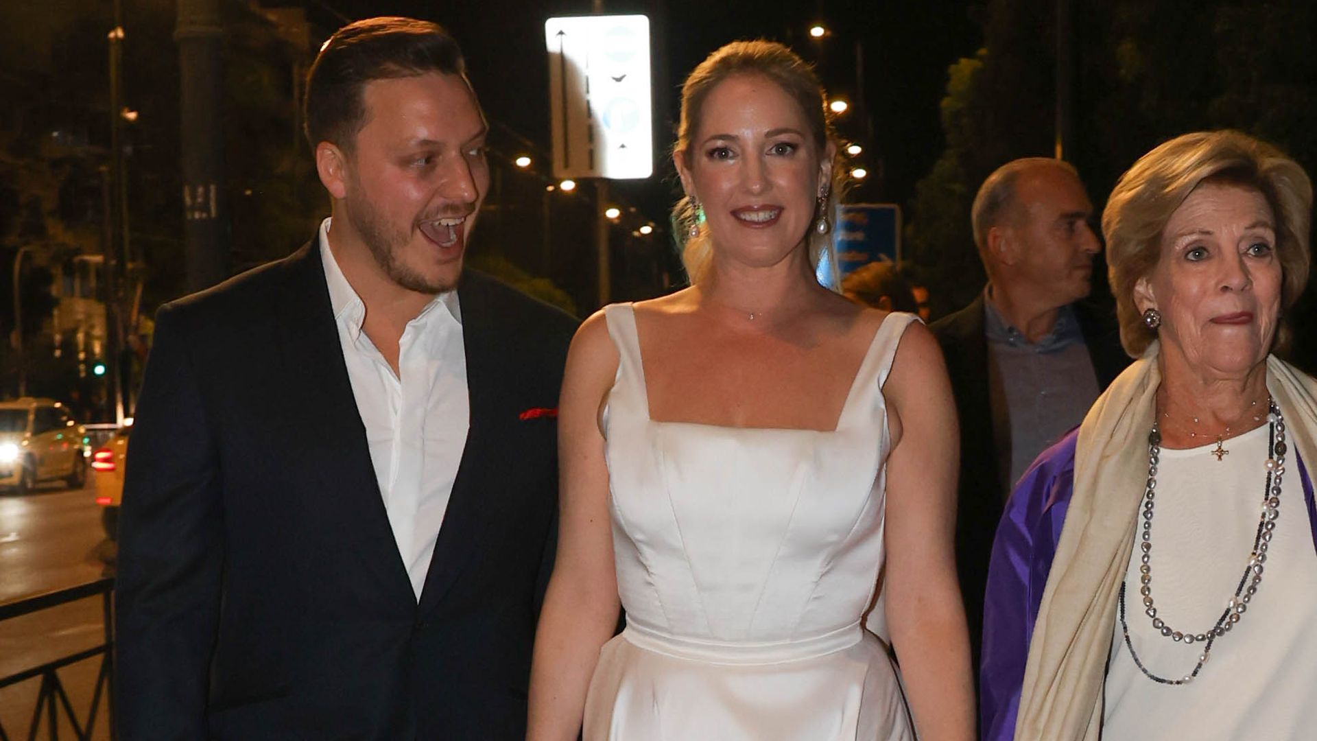 Matthew Kumar holding the hand of Princess Theodora as they walk with Queen Anne-Marie