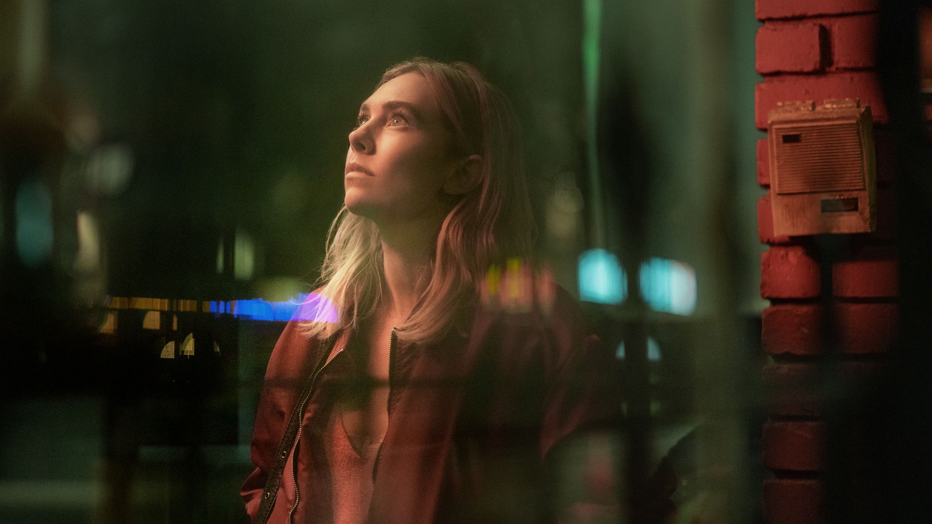 woman standing in street at night