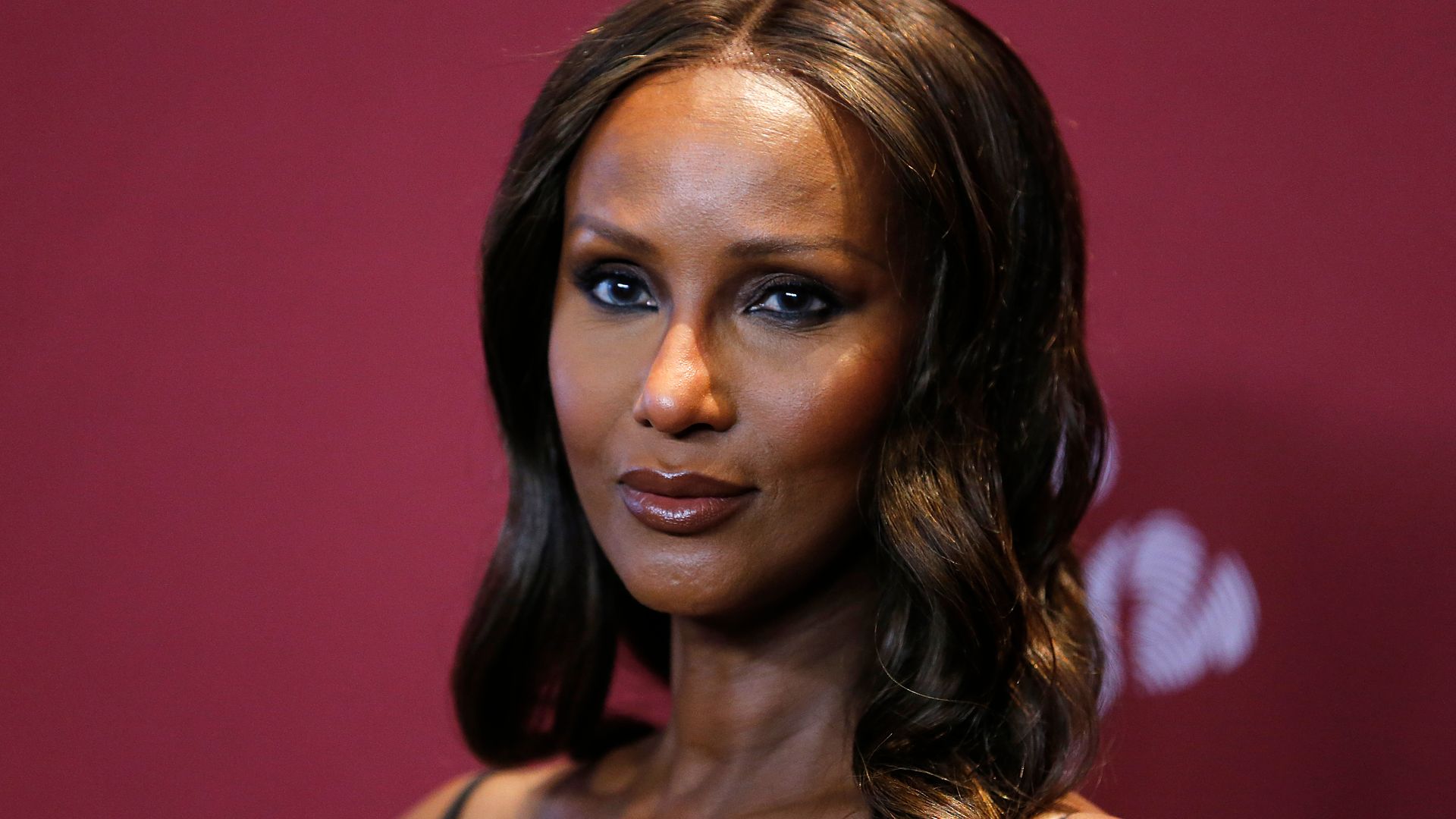 David Bowie's wife Iman, 67, shows off model figure in waist-cinching gown