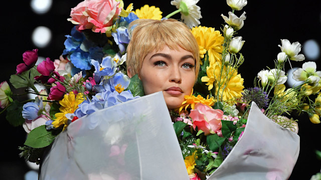 Model Gigi Hadid presents a creation for fashion house Moschino during the Women's Spring/Summer 2018 fashion shows in Milan, on September 21, 2017.  / AFP PHOTO / Marco BERTORELLO        (Photo credit should read MARCO BERTORELLO/AFP via Getty Images)