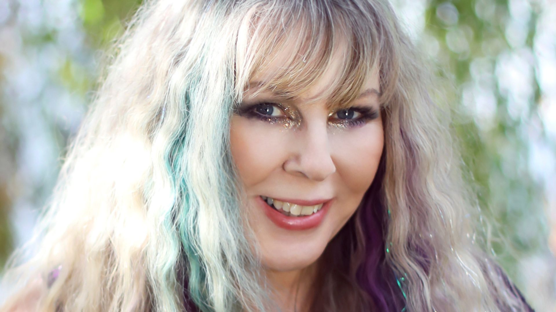 A beautiful image of Karen Kay with colours in her hair and a lovely bejewelled necklace