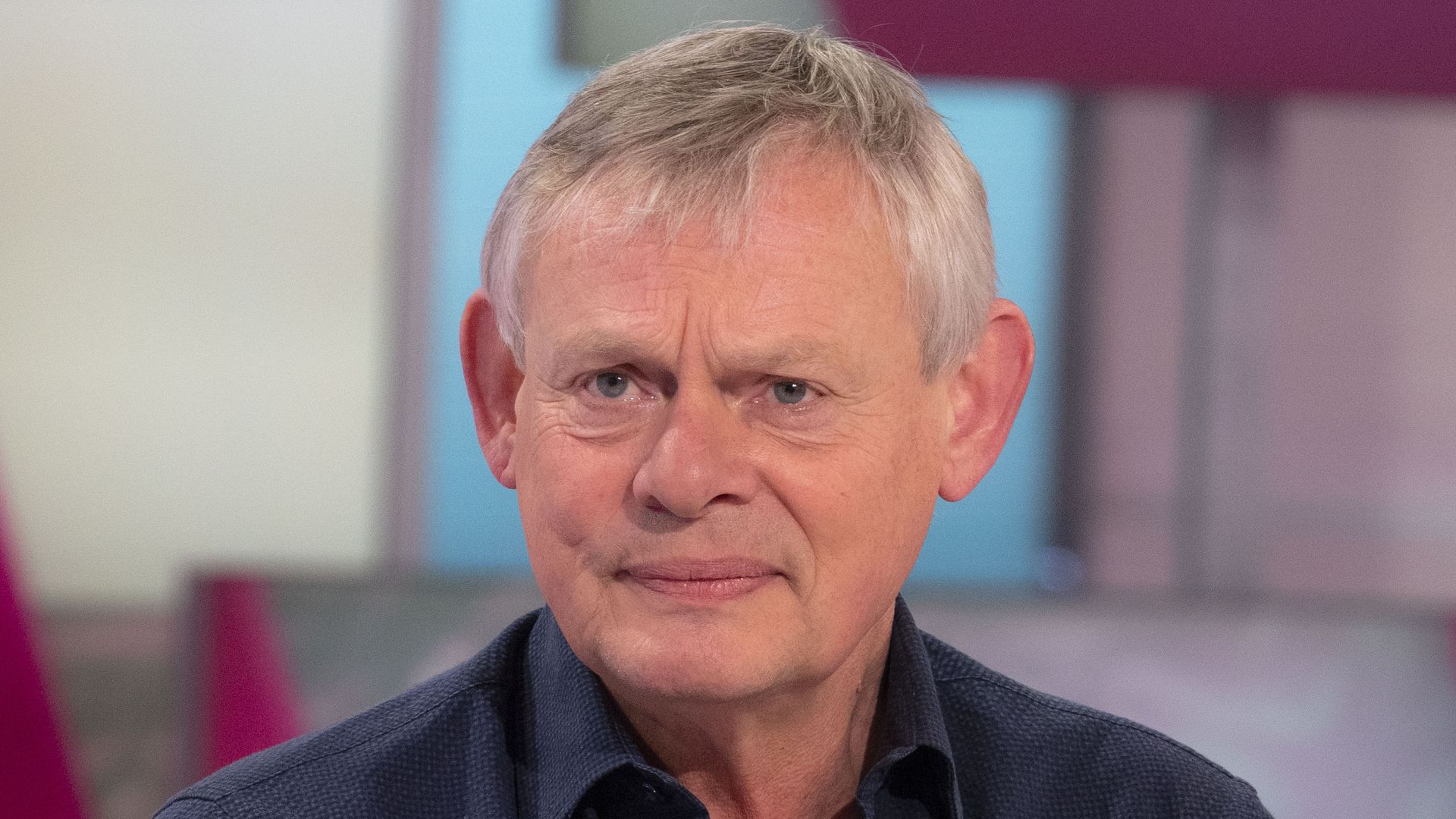 actor sitting in tv studio