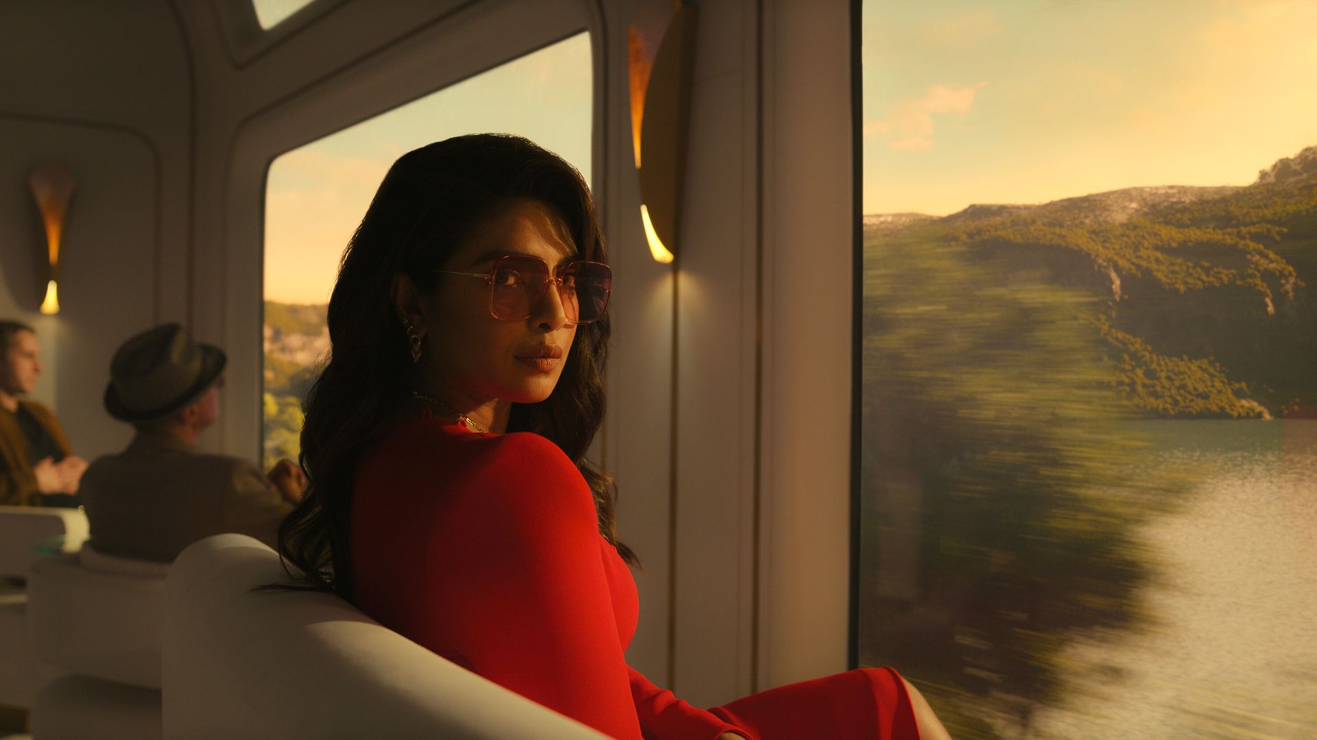 Priyanka Chopra Jonas as agent Nadia Sinh. She is wearing a red dress. 