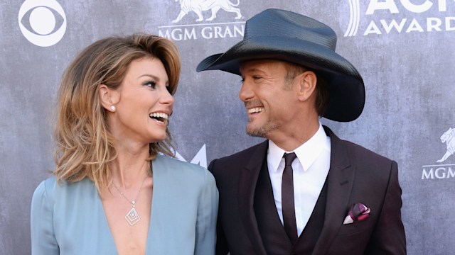 Tim McGraw and Faith Hill smiling at each other cma awards 2014