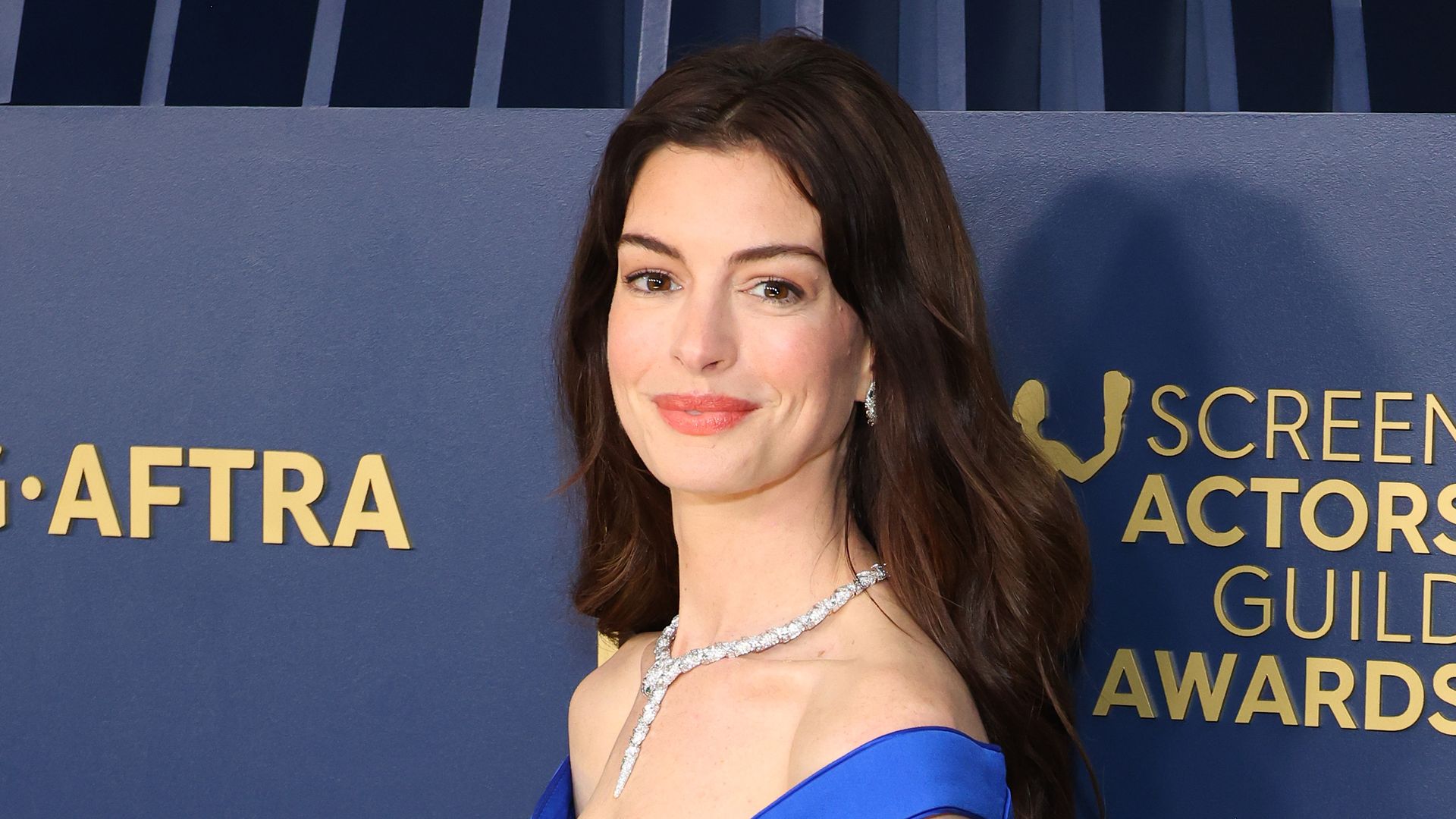 Anne Hathaway recalls suffering miscarriage at work and 'conception hell' before welcoming sons Jonathan and Jack
