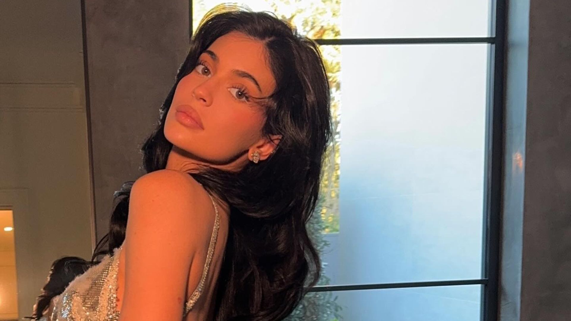 Kylie Jenner poses in a silver dress before the 2025 Golden Globes
