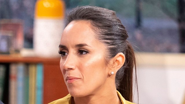 couple sat on blue sofa during talk show