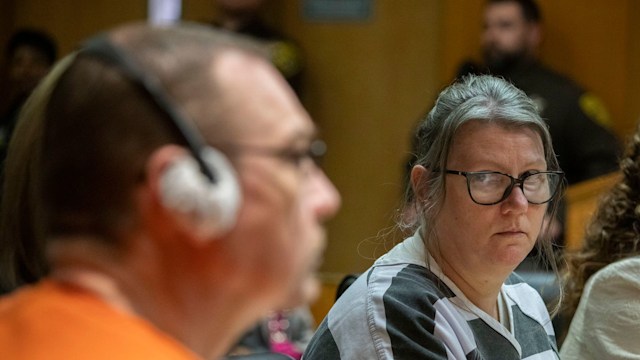 Jennifer Crumbley looks at her husband James Crumbley during their sentencing on four counts of involuntary manslaughter for the deaths of four Oxford High School students by their son, mass school shooter Ethan Crumbley, on April 9, 2024 at Oakland County Circuit Court in Pontiac, Michigan. Jennifer and James Crumbley are the first parents in U.S. history to be criminally tried and convicted for a mass school shooting that was committed by their child