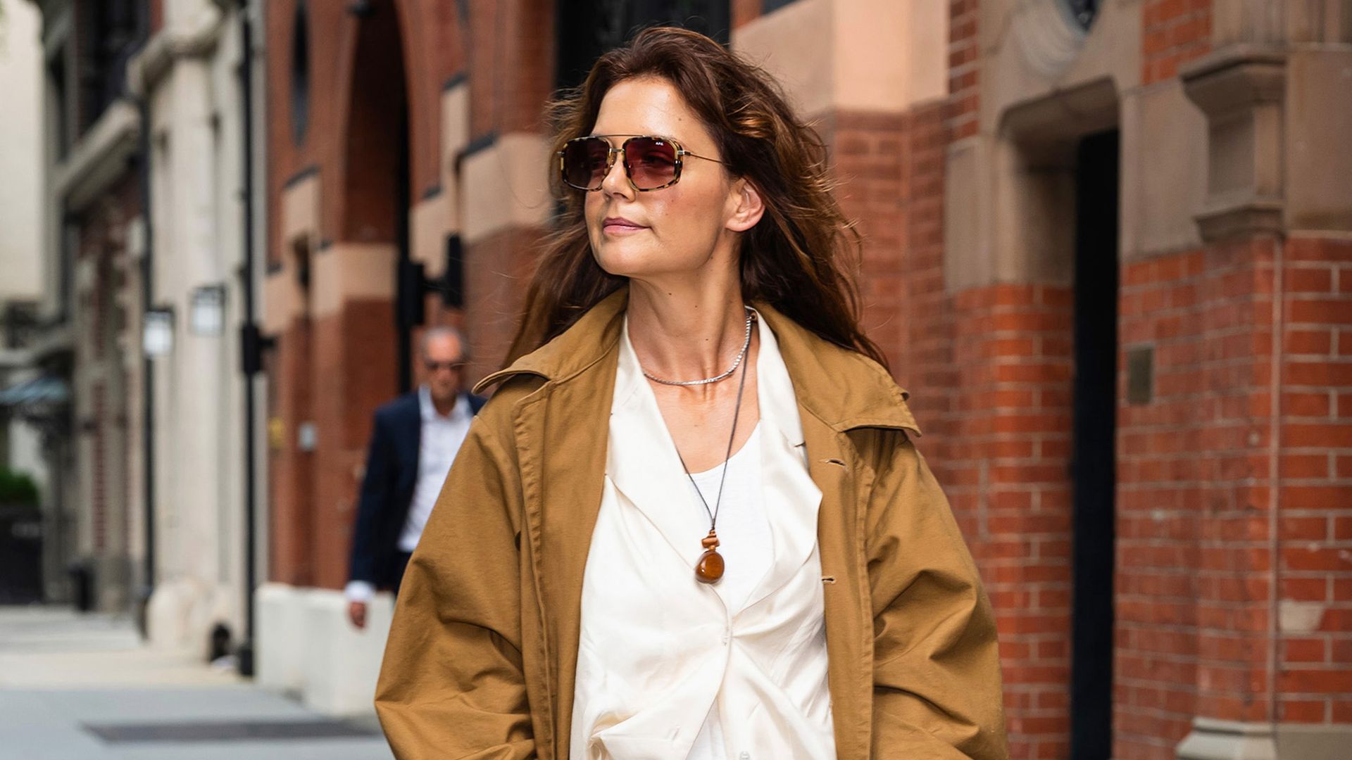 katie holmes in trench coat and red bag