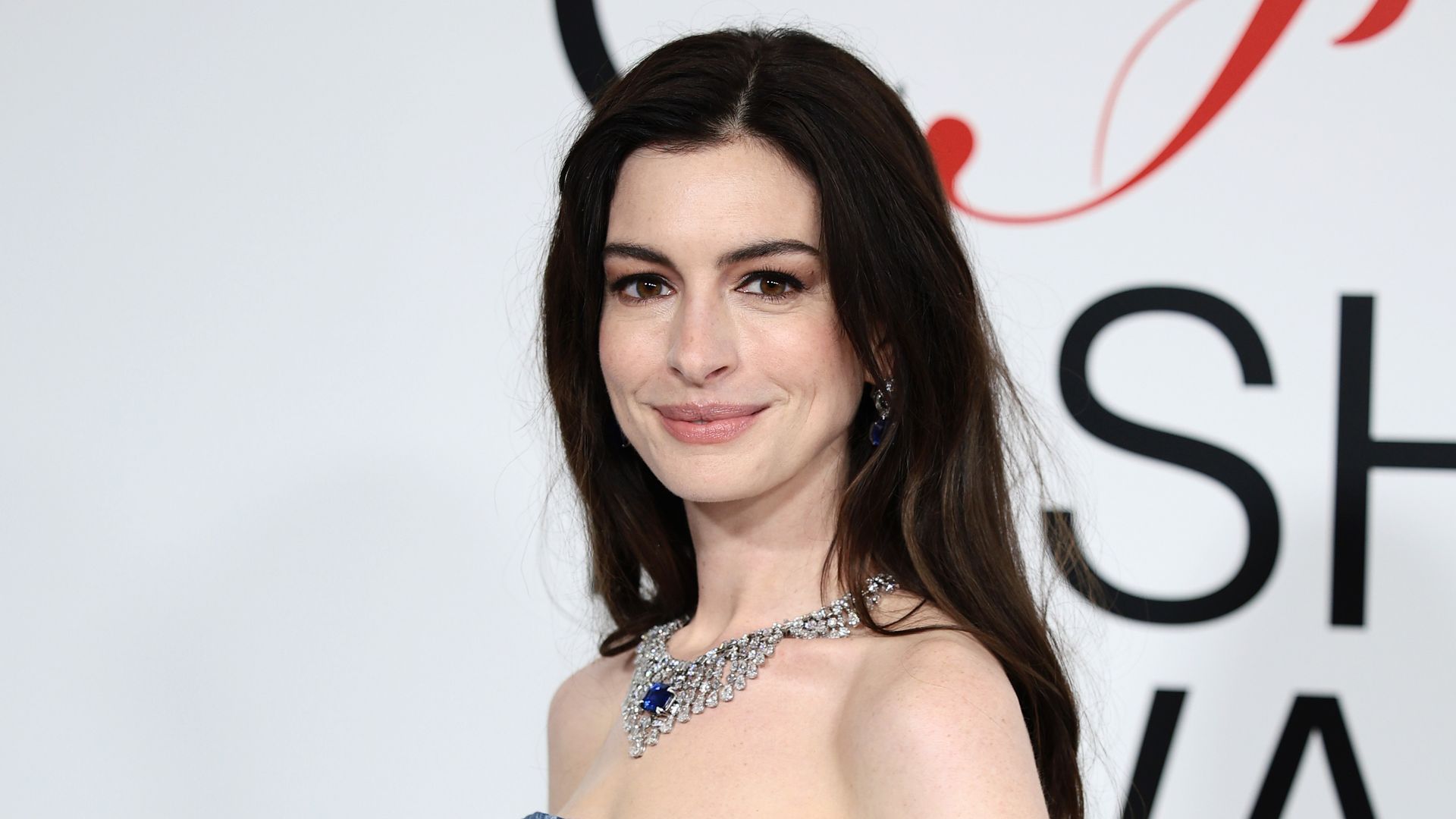 Anne Hathaway wearing double denim and a Bulgari necklace at the CFDA Awards 