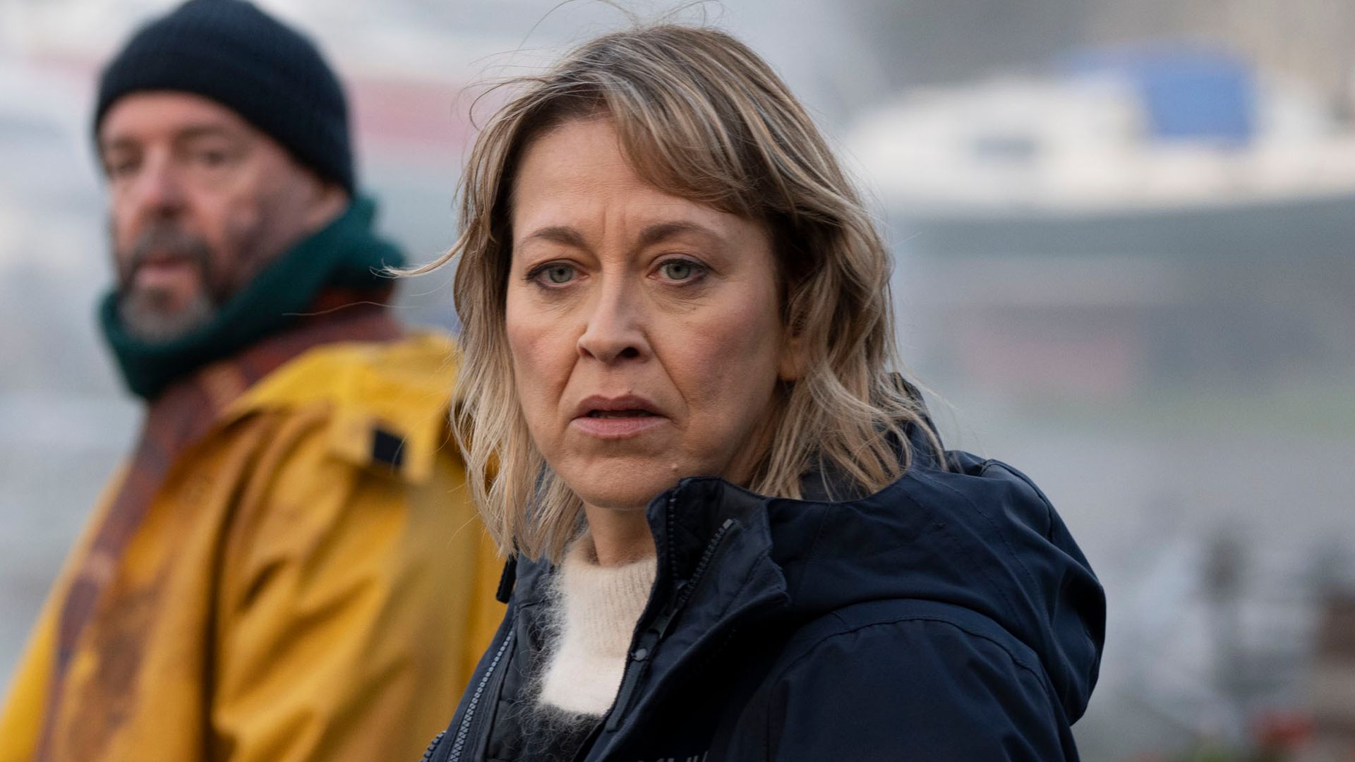 police officer standing next to man in yellow jacket