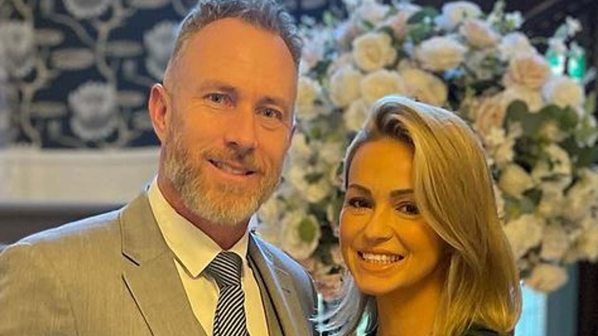 Ola Jordan in a mini dress with James Jordan in front of a staircase