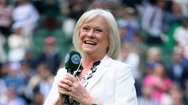 Sue Barker holds microphone at wimbledon