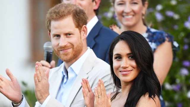 Prince Harry and Meghan Markle clapping