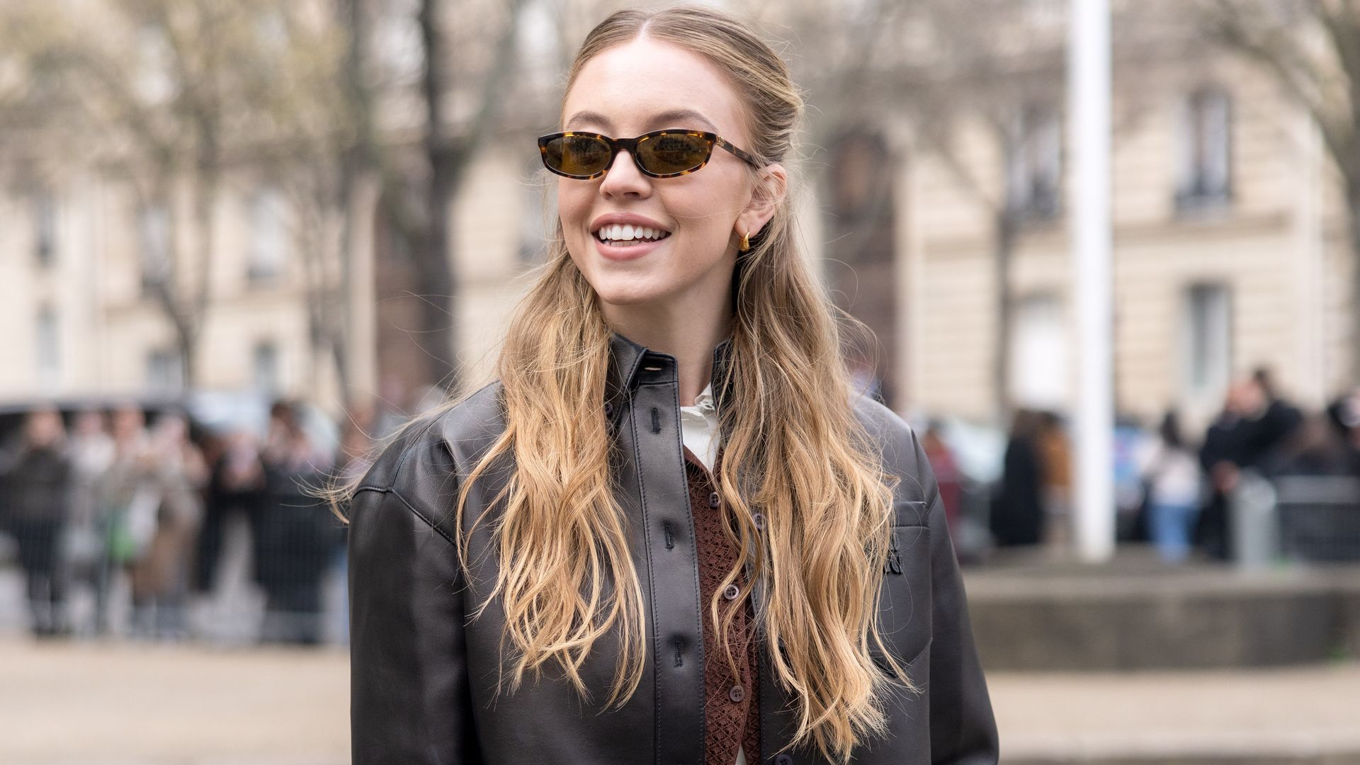 ydney Sweeney attends the Miu Miu Womenswear Fall/Winter 2025-2026 show as part of Paris Fashion Week   wearing a brown leather skirt and jacket