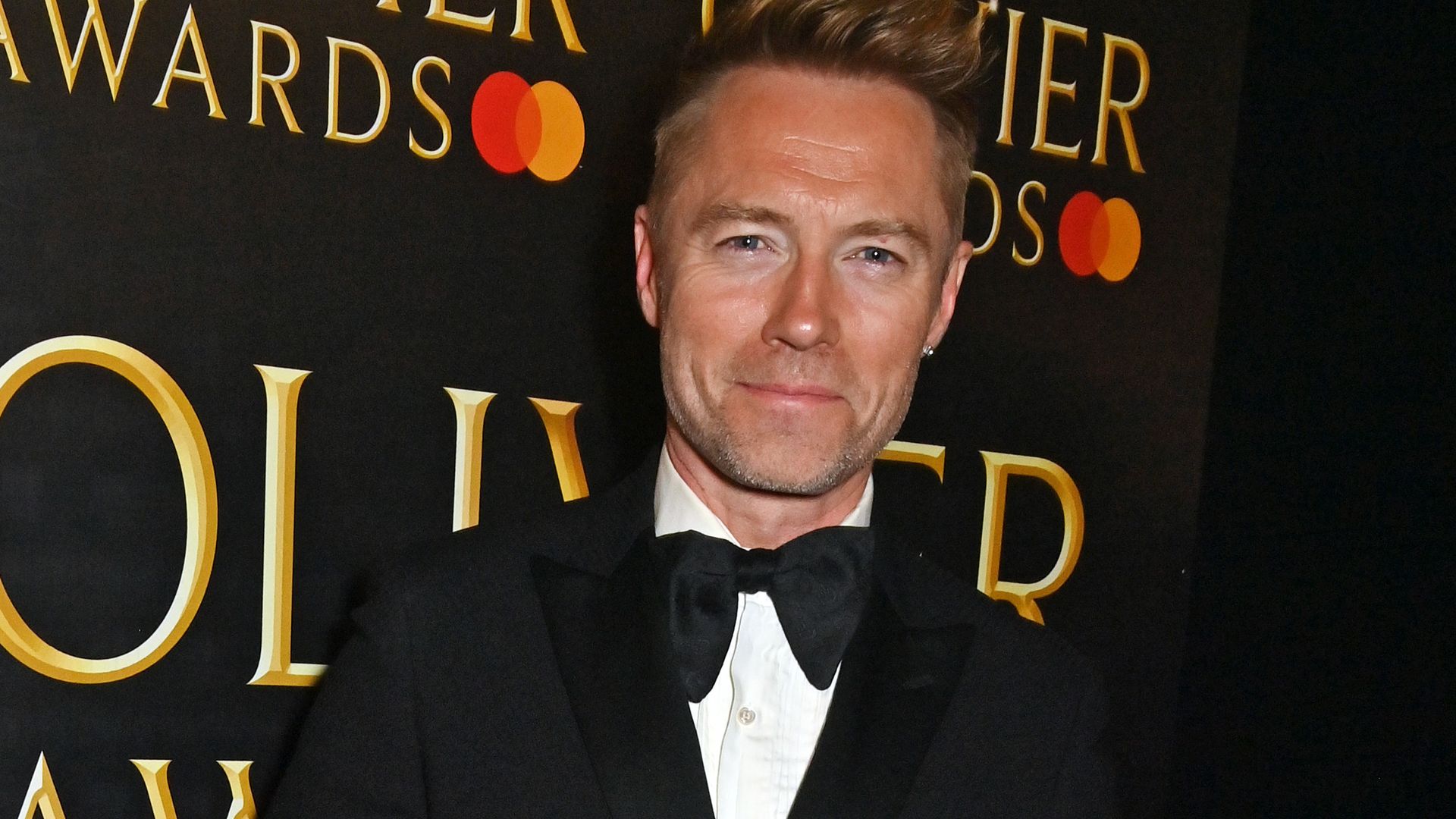 Ronan Keating smiling for a photo backstage at The Olivier Awards 2023