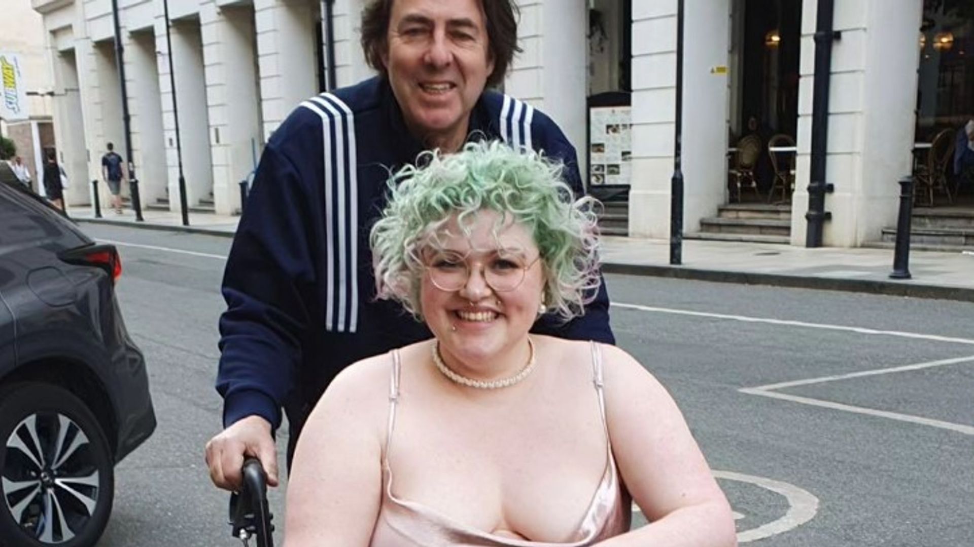 Jonathan Ross pushes his daughter Betty in a wheelchair