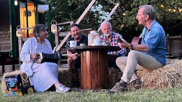 Robson Green singing around the fire with nephew Daymon