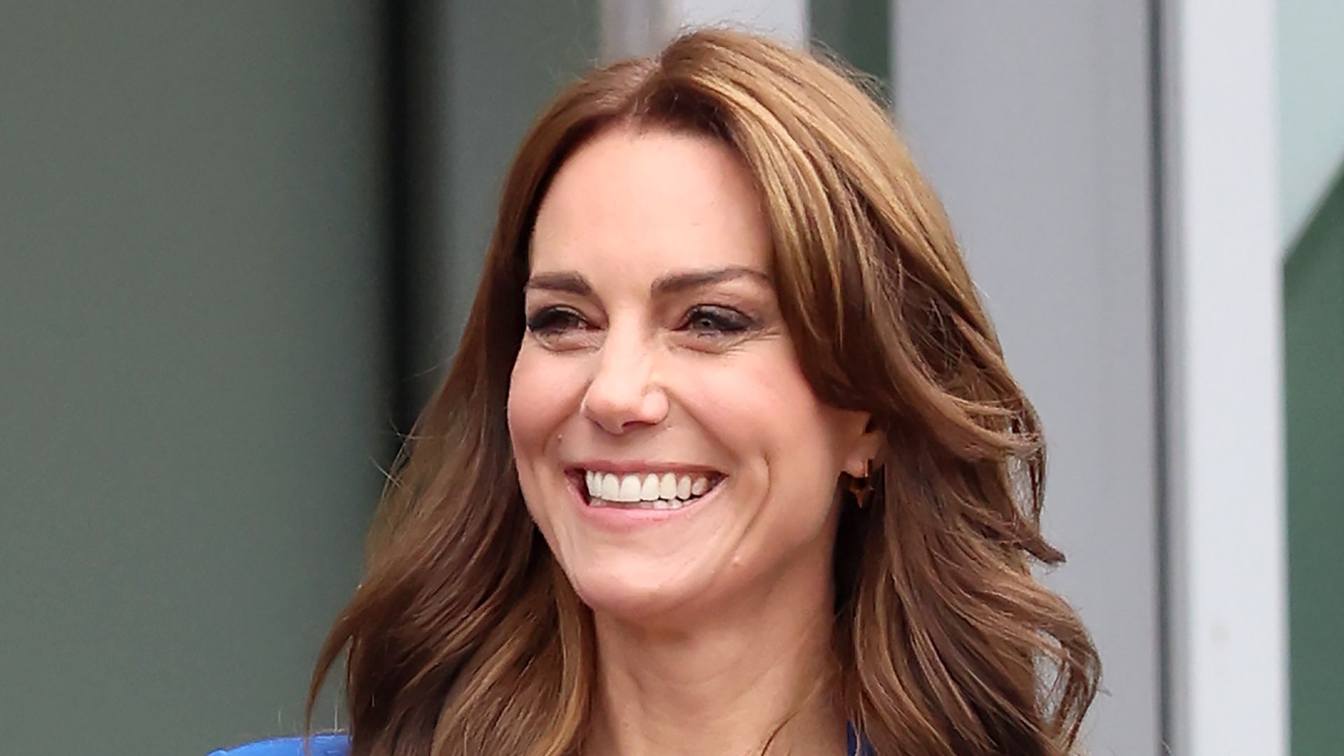 kate smiling in cobalt blazer and dark jeans