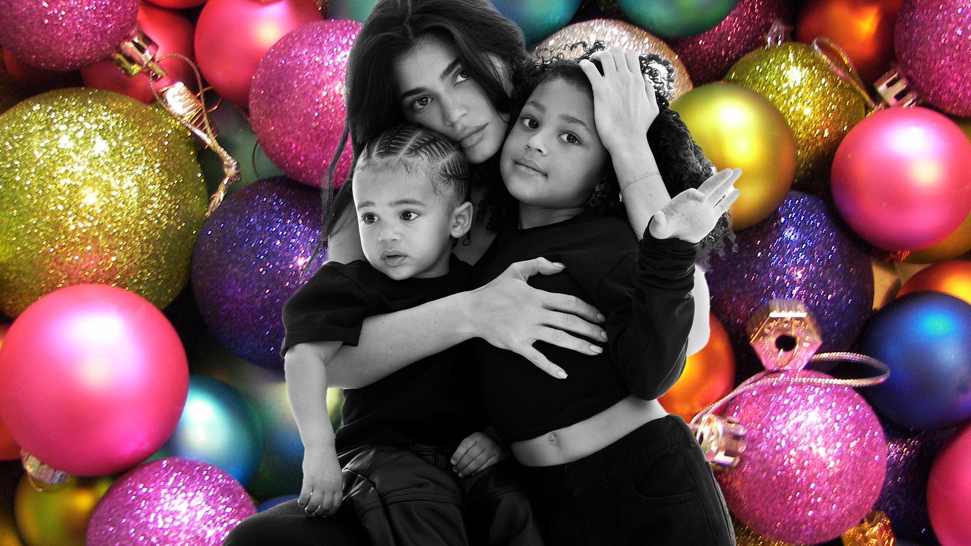 Kylie Jenner with her kids on top of a bauble background