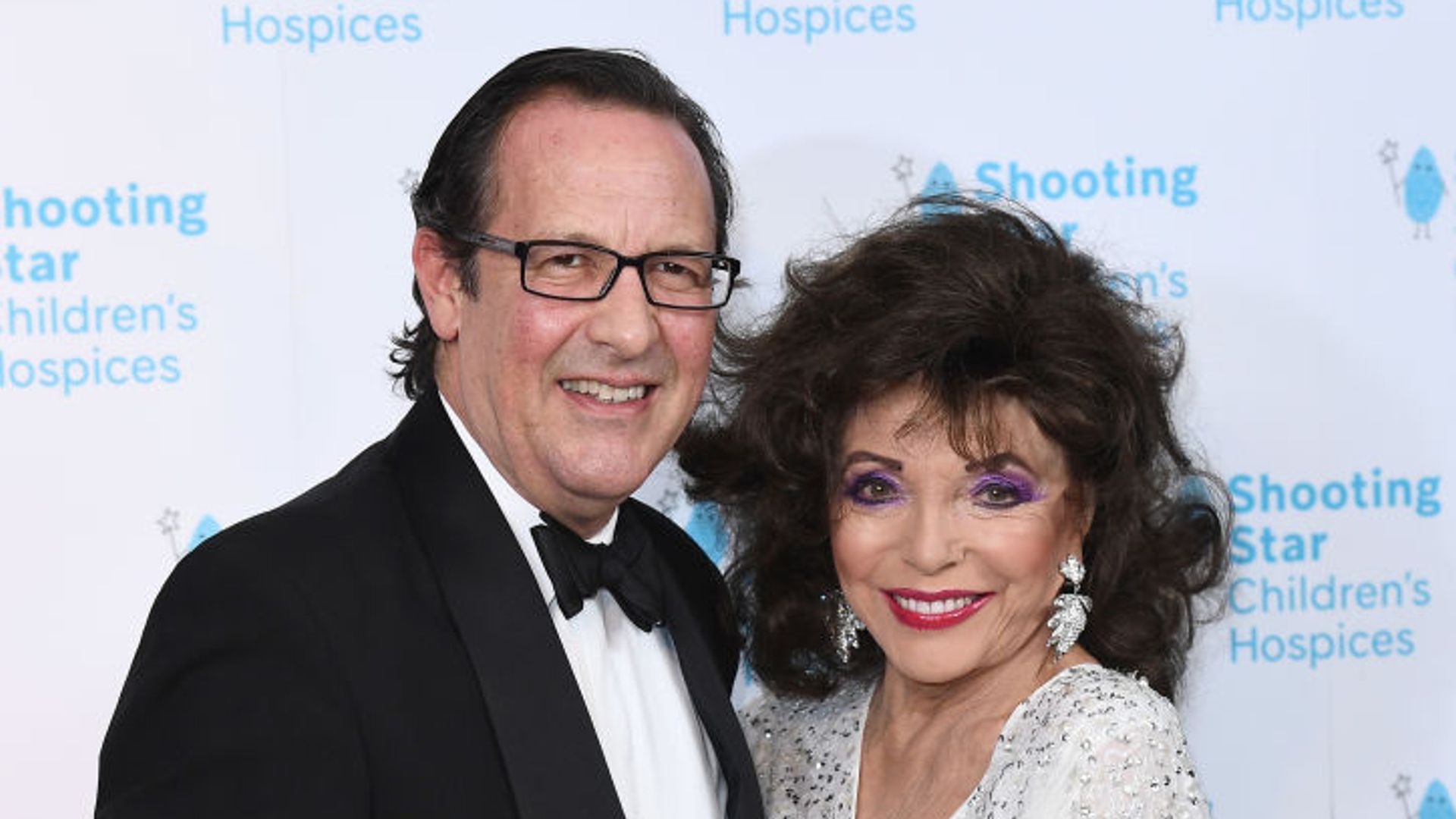 Percy Gibson and Dame Joan Collins attends the Shooting Star Ball in 2021. 