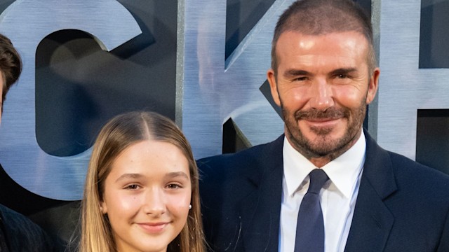 Harper Beckham and David Beckham smile at camera