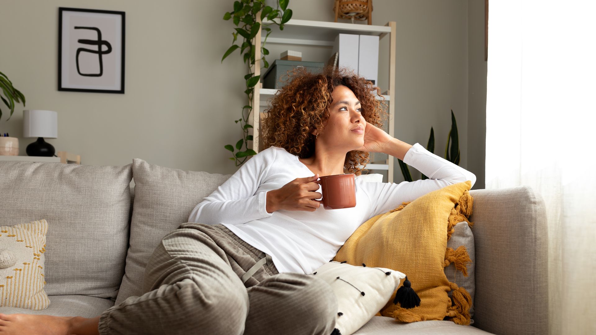 woman on sofa with cup 