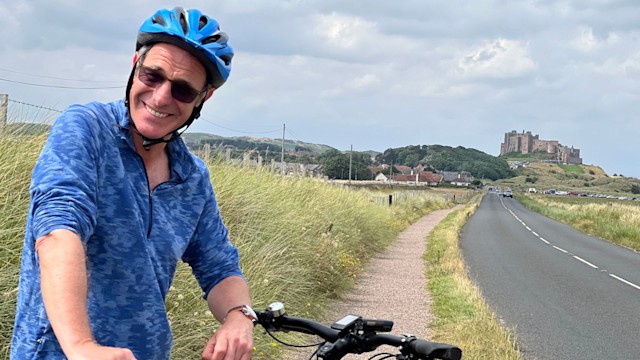 Robson Green riding a bike 