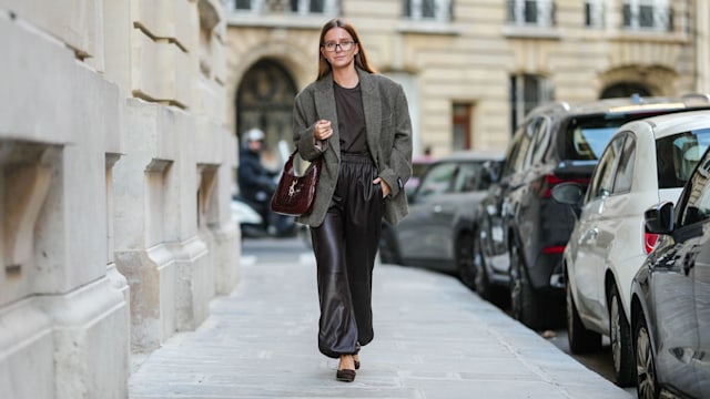 Diane Batoukina wears Tom Ford sunglasses, a dark brown the Frankie shop t-shirt, a grey oversized WRST behaviour blazer jacket, dark brown leather wide-leg The Frankie Shop pants, a burgundy leather Jackie Gucci bag, dark brown suede Manolo Blahnik pointed shoes high heels, during a street style fashion photo session, on October 23, 2024 in Paris, France. (Photo by Edward Berthelot/Getty Images)