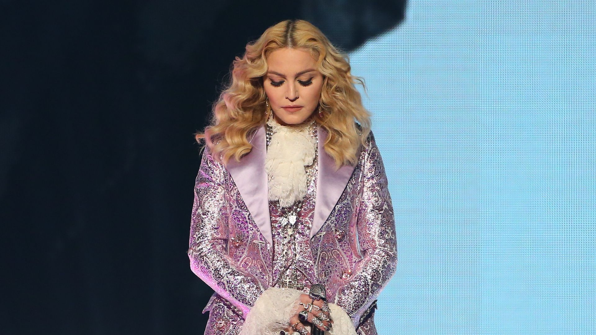 Madonna, clad in a purple suit, during a 2016 performance