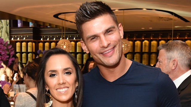 Janette Manrara in a white dress and Aljaz Skorjanec in a blue t-shirt and salmon-coloured trousers